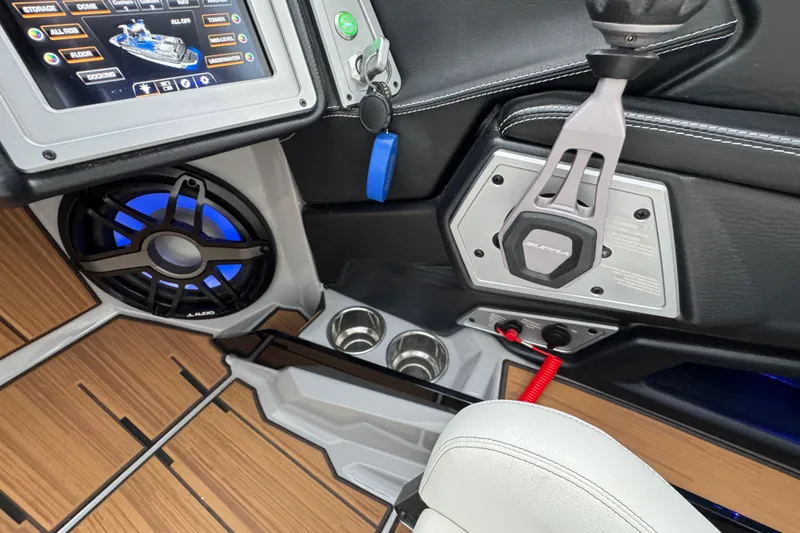 Slide: The Image of 2023 Supra SE 550 boat interior with control panel, speaker, and cup holders. - 19