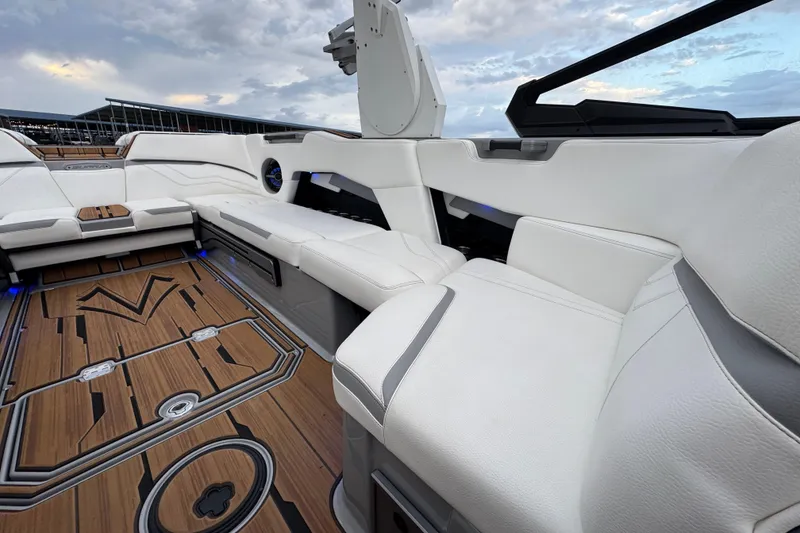 Slide: The Image of Luxurious interior of 2023 Supra SE 550 boat with white seating and wooden flooring. - 23
