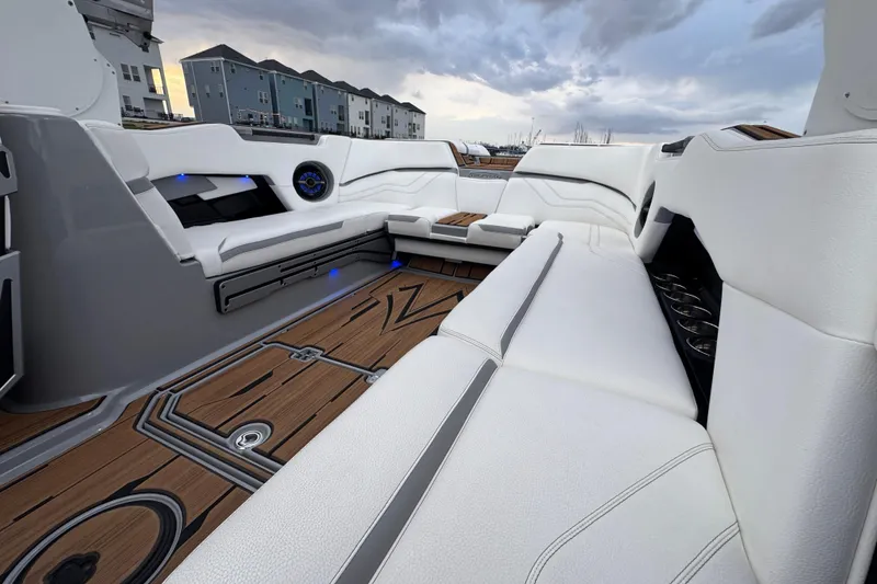 Slide: The Image of Luxurious interior of 2023 Supra SE 550 boat with white seating and wooden flooring. - 24