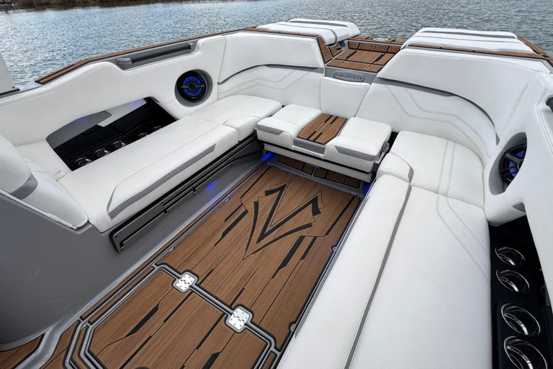 Slide: The Image of Luxurious interior of 2023 Supra SE 550 boat with white seating and wood accents. - 28