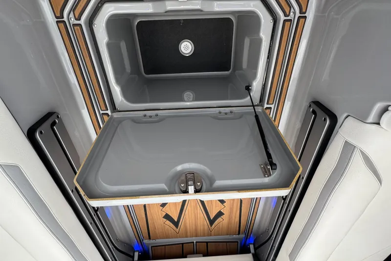 Slide: The Image of 2023 Supra SE 550 interior storage compartment with sleek design and wood accents. - 29