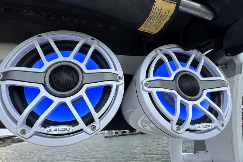 Slide: The Image of JL Audio speakers with blue LED lights on a 2023 Supra SE 550 boat. - 37