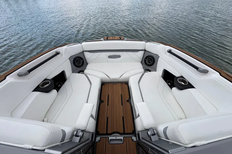 Slide: The Image of Luxurious interior of 2023 Supra SE 550 boat with white seating and wood accents. - 8