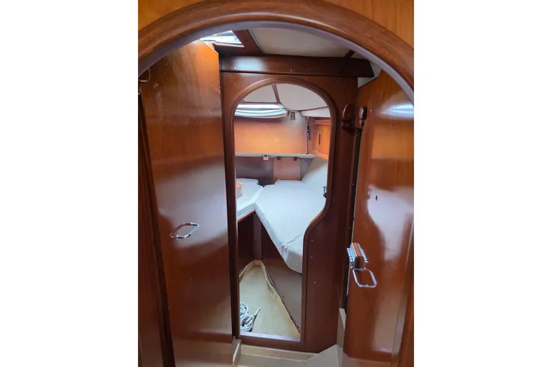 Slide: The Image of Interior cabin of 1988 Amel Sharki sailboat with wooden finish and cozy bed. - 10