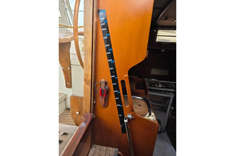 Slide: The Image of Interior of 1988 Amel Sharki sailboat with wooden panel and measurement scale. - 12