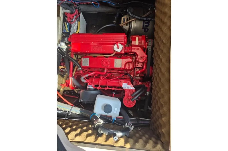 Slide: The Image of Red engine in 1988 Amel Sharki boat, surrounded by cables and components. - 13