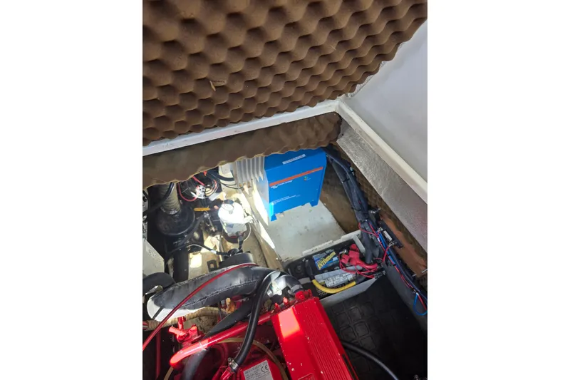 Slide: The Image of Engine compartment of a 1988 Amel Sharki sailboat with visible wiring and components. - 15