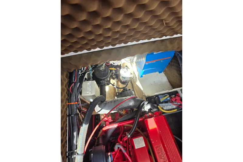 Slide: The Image of Engine compartment of 1988 Amel Sharki sailboat with red Beta Marine engine. - 16