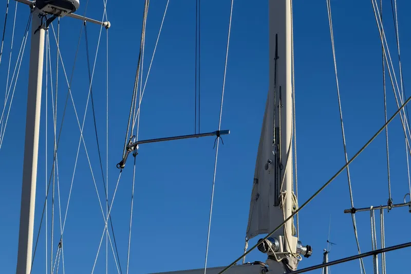 Slide: The Image of Mast and rigging of 1988 Amel Sharki sailboat against clear blue sky. - 3