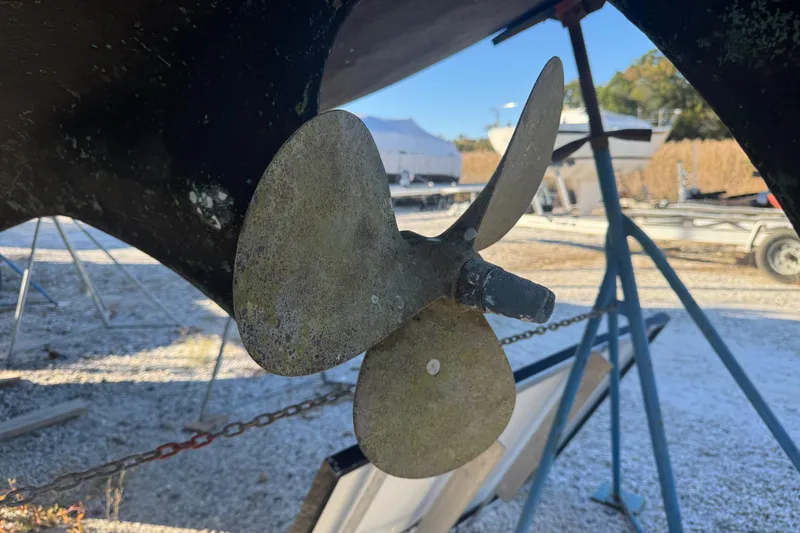 Slide: The Image of Close-up of a 1988 Amel Sharki boat propeller on a stand outdoors. - 7