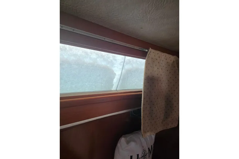 Slide: The Image of Interior view of 1988 Amel Sharki boat with snow-covered window and curtain. - 9