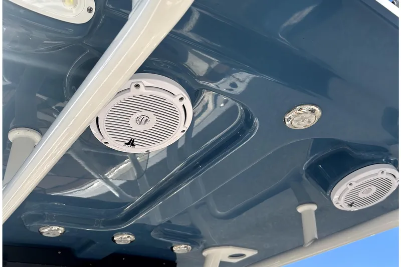 Slide: The Image of 2023 Pioneer 222 Islander boat speakers and lights on blue ceiling. - 14