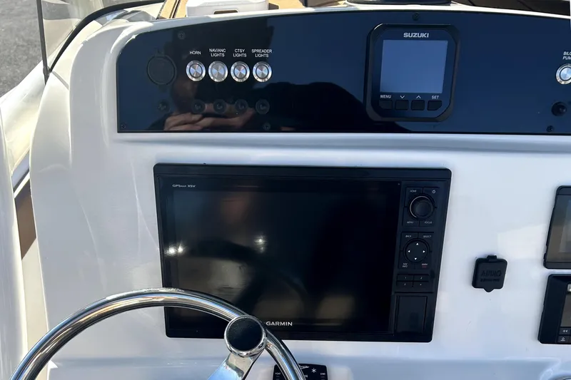 Slide: The Image of Dashboard of 2023 Pioneer 222 Islander boat with Garmin and Suzuki displays. - 16
