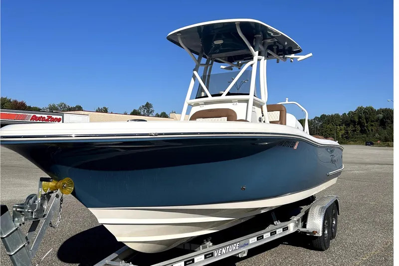 Slide: The Image of 2023 Pioneer 222 Islander boat on trailer under clear blue sky. - 3