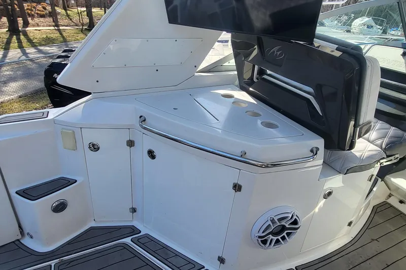 Slide: The Image of 2016 Monterey 335 Sport Yacht interior with seating and storage compartments. - 11