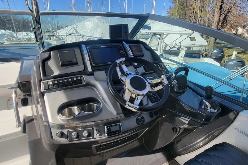 Slide: The Image of Control panel of 2016 Monterey 335 Sport Yacht with steering wheel and navigation equipment. - 12