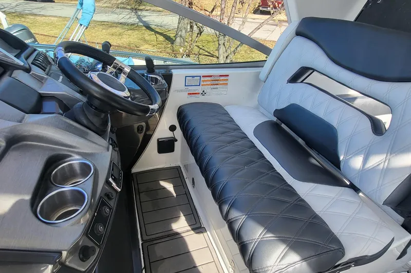 Slide: The Image of 2016 Monterey 335 Sport Yacht cockpit with luxurious seating and modern steering wheel. - 13
