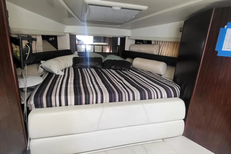 Slide: The Image of Interior cabin of 2016 Monterey 335 Sport Yacht with striped bedding and modern decor. - 15