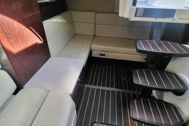 Slide: The Image of Interior of 2016 Monterey 335 Sport Yacht with wooden flooring and beige seating. - 16