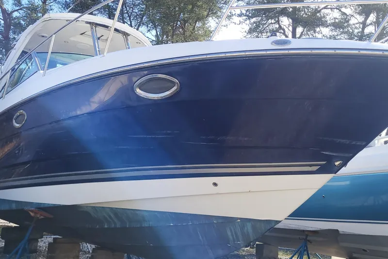 Slide: The Image of 2016 Monterey 335 Sport Yacht with sleek blue hull, docked outdoors. - 2