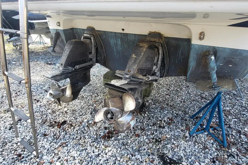 Slide: The Image of 2016 Monterey 335 Sport Yacht propellers and stern on gravel, supported by stands. - 3