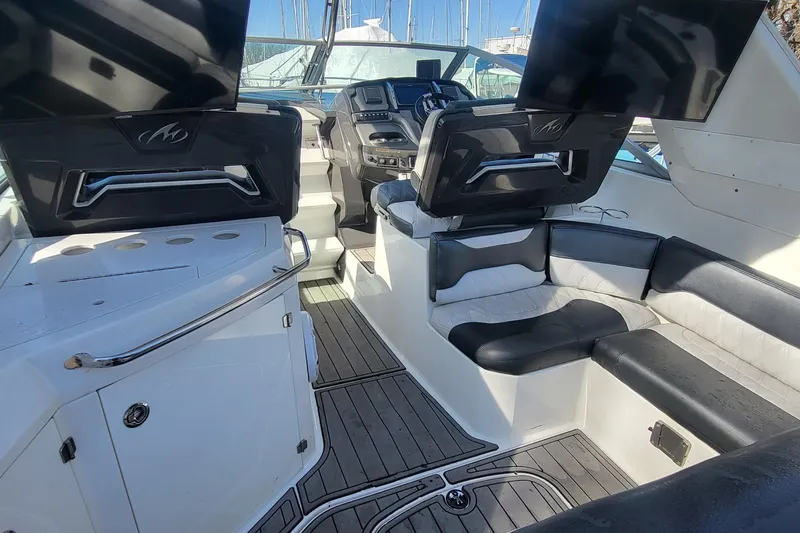 Slide: The Image of 2016 Monterey 335 Sport Yacht interior with sleek seating and modern dashboard. - 7