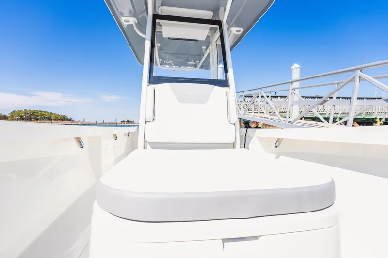 Slide: The Image of 2023 Parker 2400 boat with sleek design, docked under clear blue sky. - 16