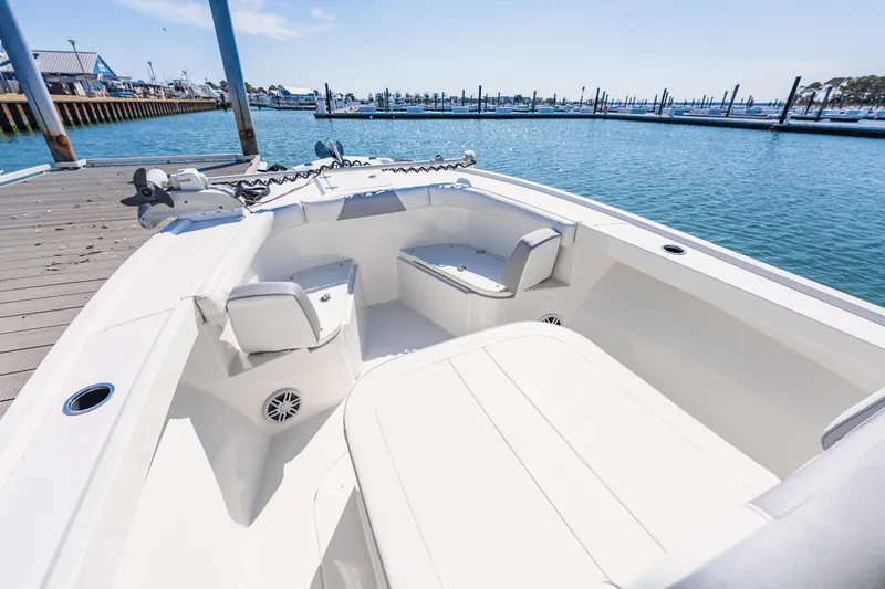 Slide: The Image of 2023 Parker 2400 boat interior at dock, featuring spacious seating and modern design. - 17