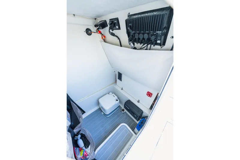 Slide: The Image of Interior of 2023 Parker 2400 boat featuring storage and equipment compartments. - 22