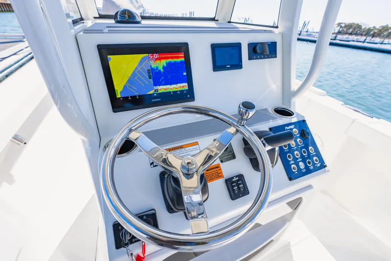 Slide: The Image of Control panel of 2023 Parker 2400 boat with steering wheel and navigation display. - 8