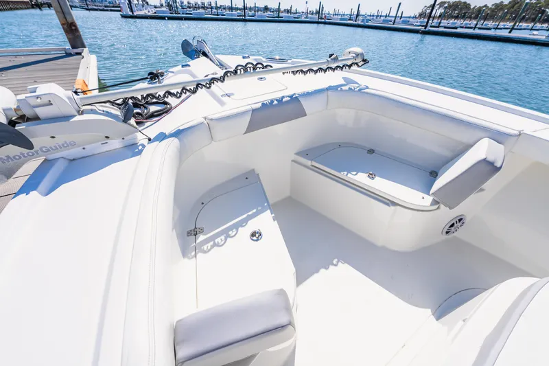 Slide: The Image of 2023 Parker 2400 boat interior with cushioned seating and MotorGuide trolling motor. - 9
