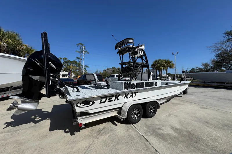 Slide: The Image of 2023 Dek Kat 27 Trilogy boat on trailer, outdoor setting, clear sky. - 10