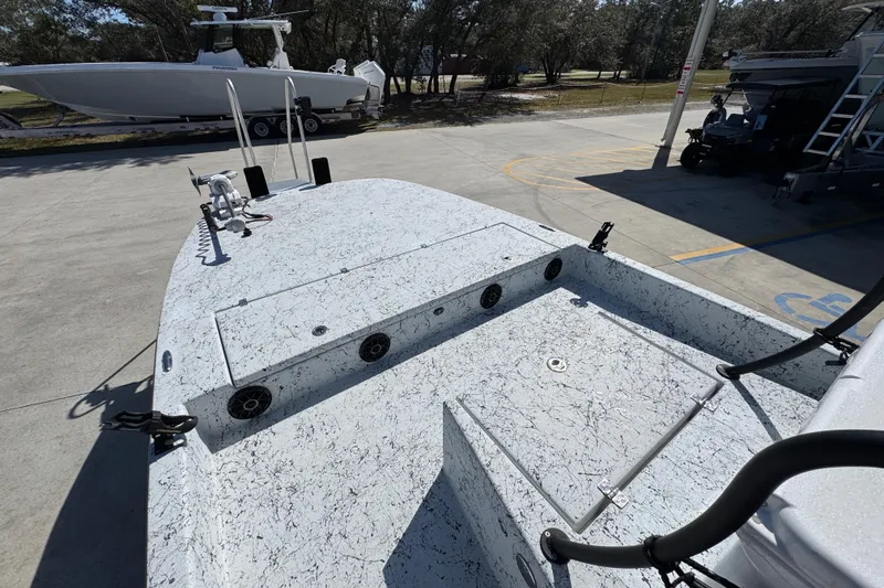 Slide: The Image of 2023 Dek Kat 27 Trilogy boat on trailer, featuring a speckled deck design. - 18