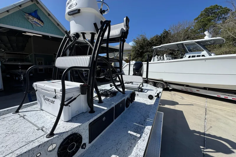 Slide: The Image of 2023 Dek Kat 27 Trilogy boat with Seaguar cooler, parked outdoors. - 24