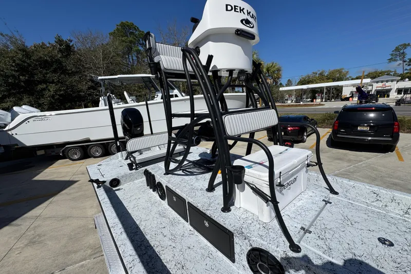 Slide: The Image of 2023 Dek Kat 27 Trilogy boat with elevated seating and cooler on deck. - 25