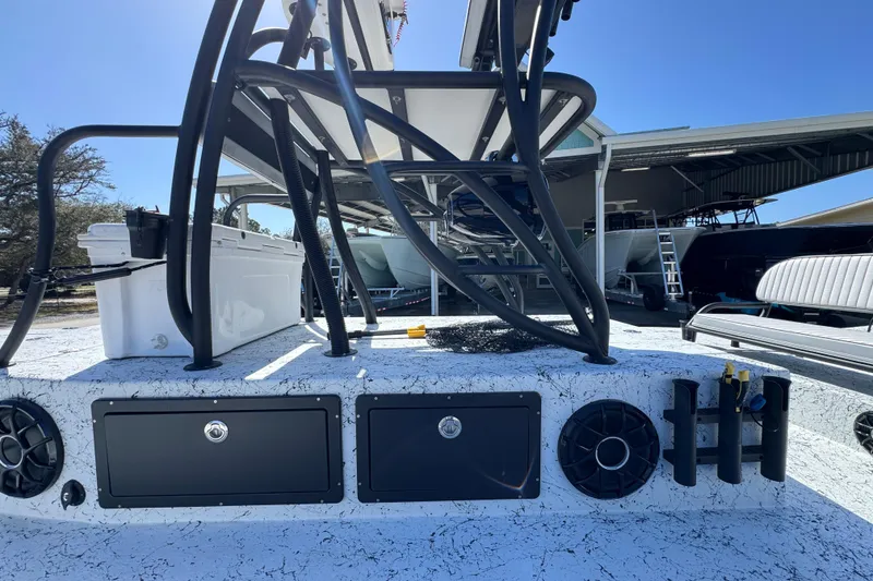 Slide: The Image of 2023 Dek Kat 27 Trilogy boat deck with storage compartments and speakers. - 26