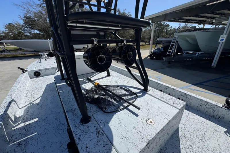 Slide: The Image of 2023 Dek Kat 27 Trilogy boat deck with fishing gear and speakers. - 30