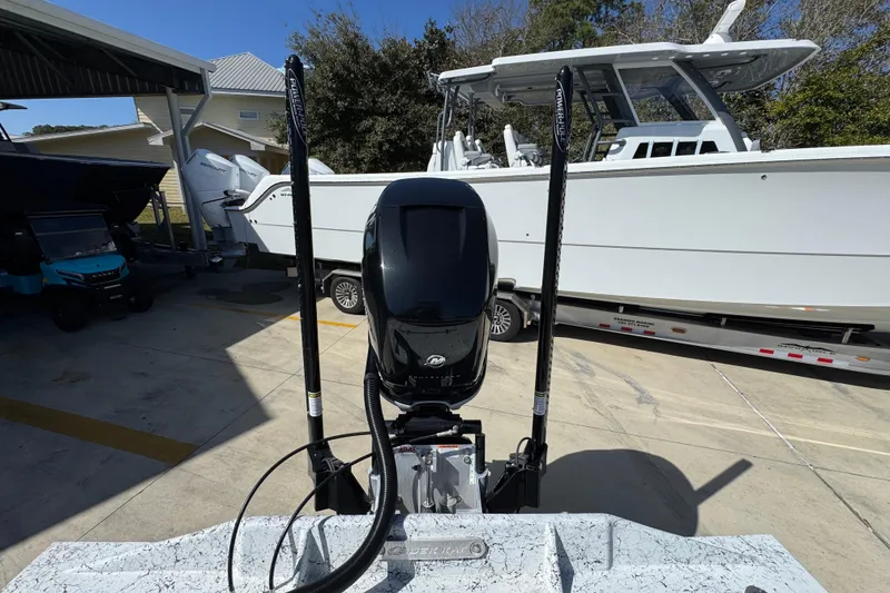 Slide: The Image of 2023 Dek Kat 27 Trilogy boat with powerful outboard motor in a marina setting. - 38