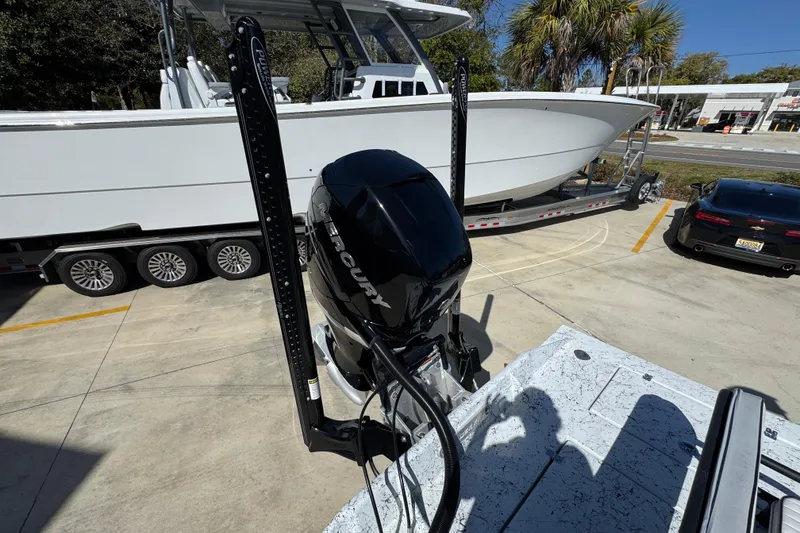 Slide: The Image of 2023 Dek Kat 27 Trilogy boat with Mercury engine on trailer in parking lot. - 40