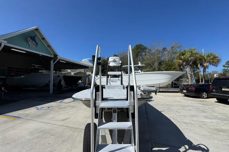 Slide: The Image of 2023 Dek Kat 27 Trilogy boat displayed outdoors under clear blue sky. - 5