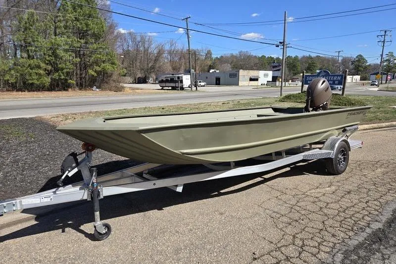 The Image of 2025 Tracker Grizzly 2072 Utility boat on trailer, parked outdoors on a sunny day. - 0
