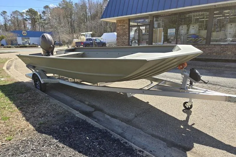 Slide: The Image of 2025 Tracker Grizzly 2072 Utility boat on trailer outside a store. - 7