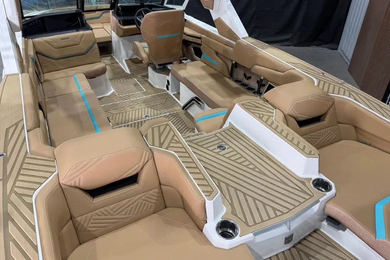 Slide: The Image of 2025 MasterCraft XStar 23 interior with tan upholstery and modern design. - 10