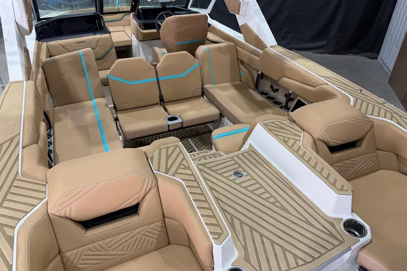 Slide: The Image of 2025 MasterCraft XStar 23 boat interior with tan and blue seating, modern design. - 11
