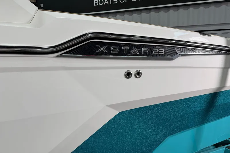 Slide: The Image of 2025 MasterCraft XStar 23 boat side view with sleek design and modern detailing. - 3