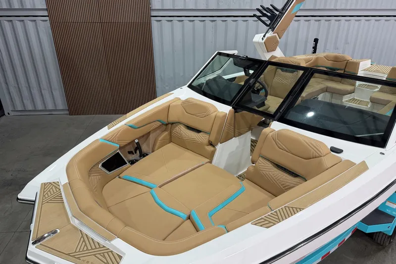 Slide: The Image of 2025 MasterCraft XStar 23 boat interior with tan and turquoise seating, modern design. - 4