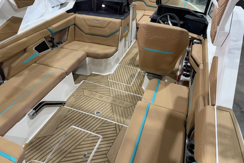 Slide: The Image of 2025 MasterCraft XStar 23 interior with tan and teal seating, modern design. - 7