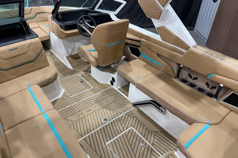 Slide: The Image of 2025 MasterCraft XStar 23 boat interior with tan and turquoise seating, modern design. - 8