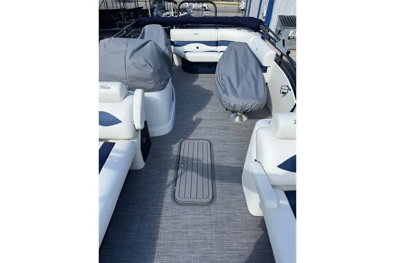 Slide: The Image of 2026 JC 23 Neptoon TT Sport boat interior with covered seating and sleek flooring. - 15