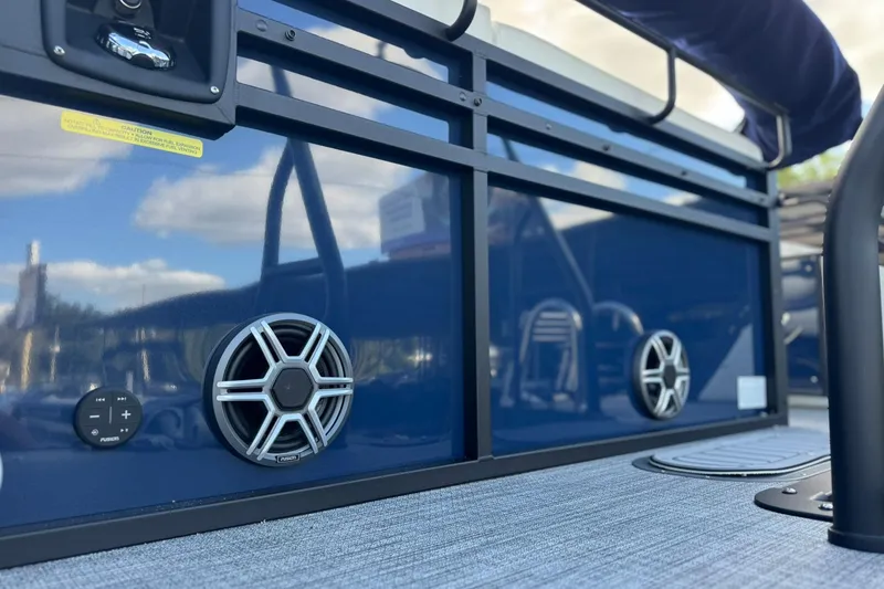 Slide: The Image of 2026 JC 23 Neptoon TT Sport boat with sleek blue paneling and integrated speakers. - 18